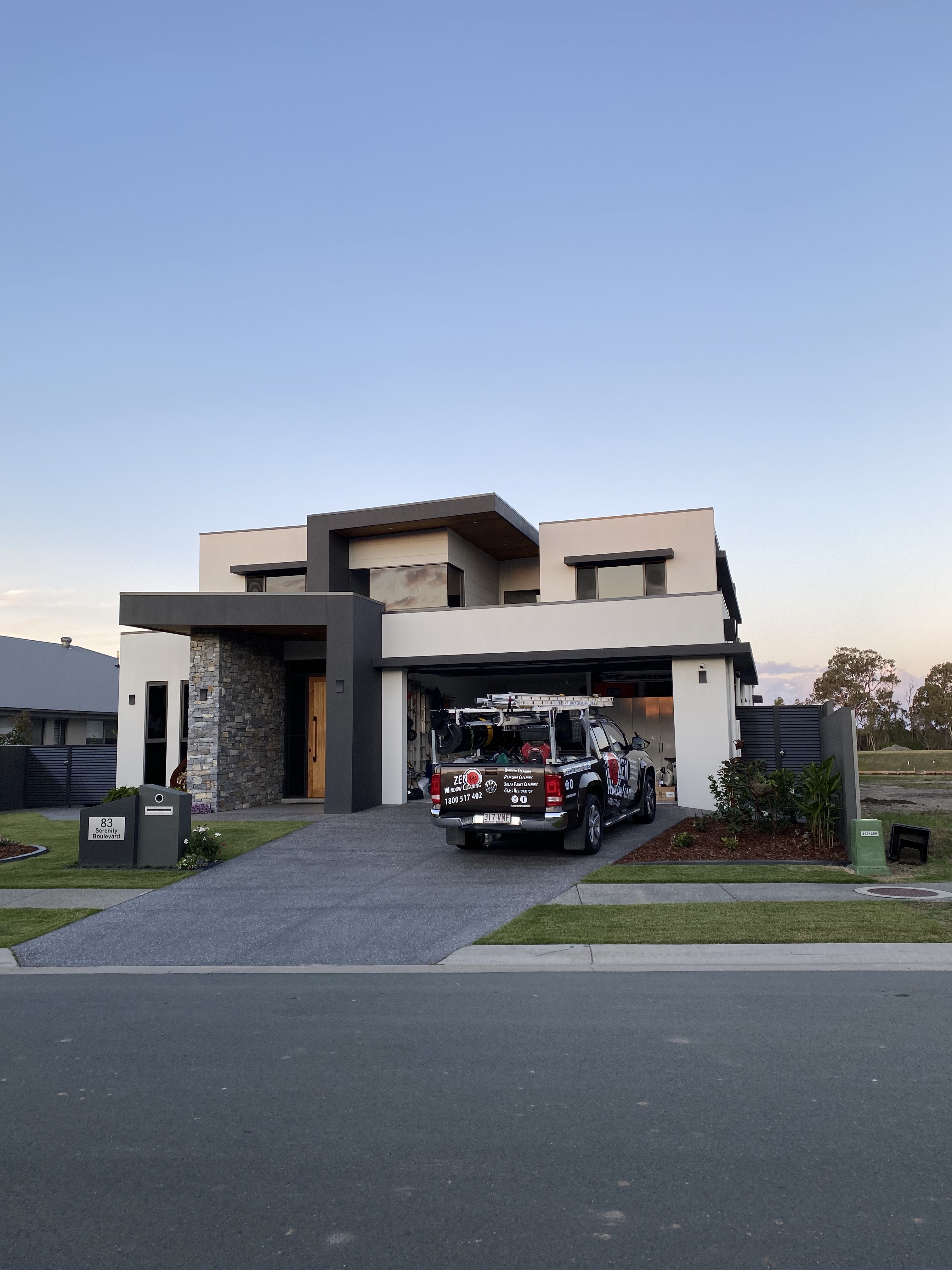 Zen Window Cleaning branded ute parked on the driveway of a modern Gold Coast home, ready for the job