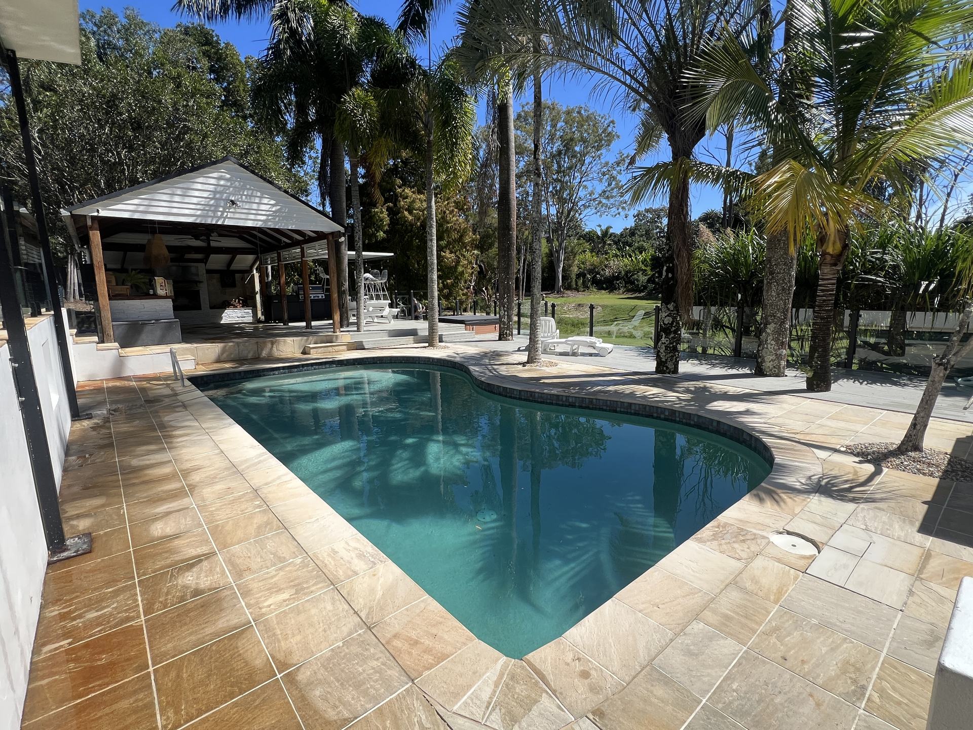 The same pool surrounds after pressure cleaning, natural golden sandstone tone restored