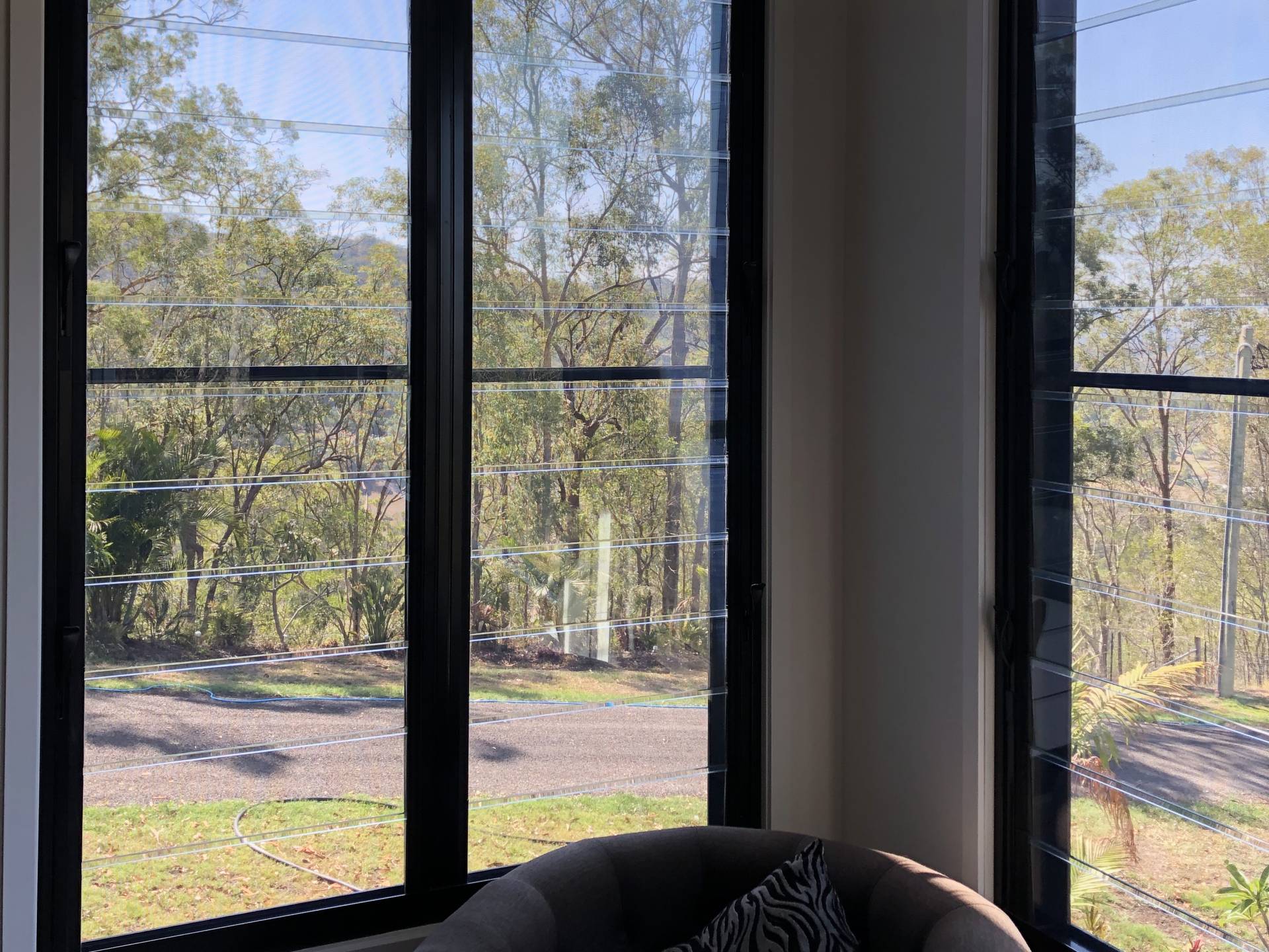 Clean interior glass looking out to the trees at a Currumbin Valley home