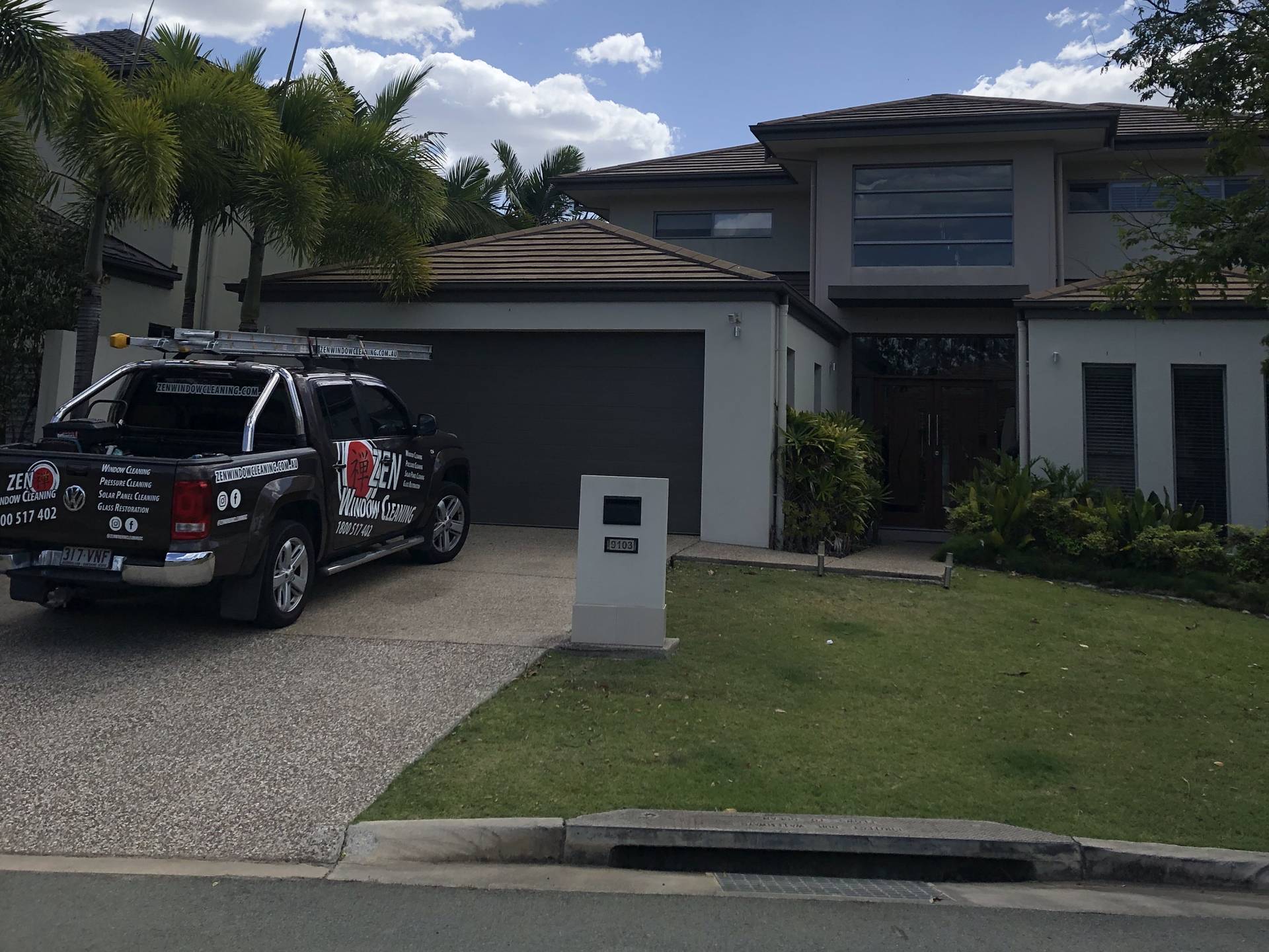 Zen Window Cleaning ute in the driveway of a Hope Island home