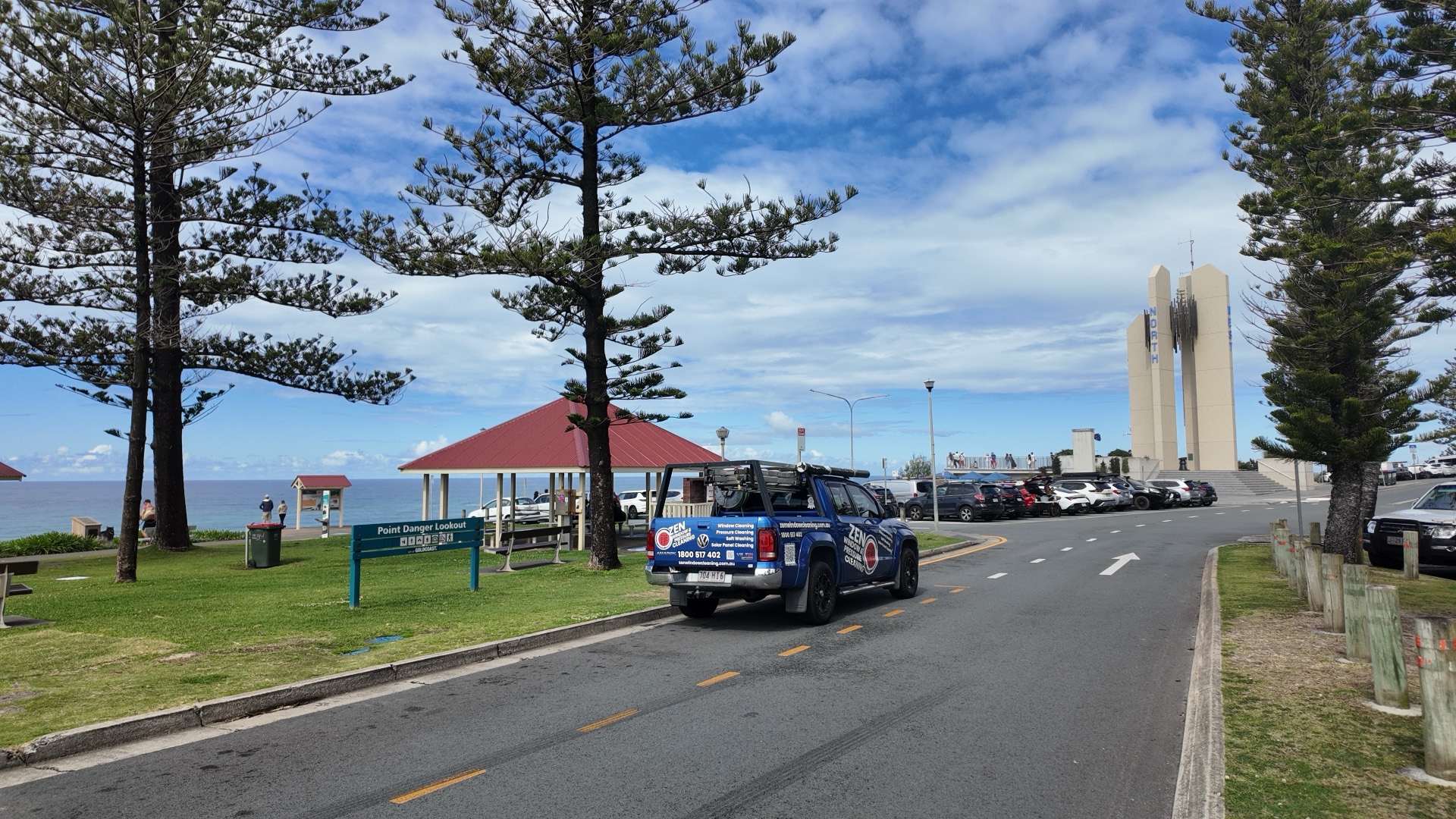Zen Window Cleaning ute at the Point Danger lookout on the Coolangatta headland, Norfolk pines and ocean behind