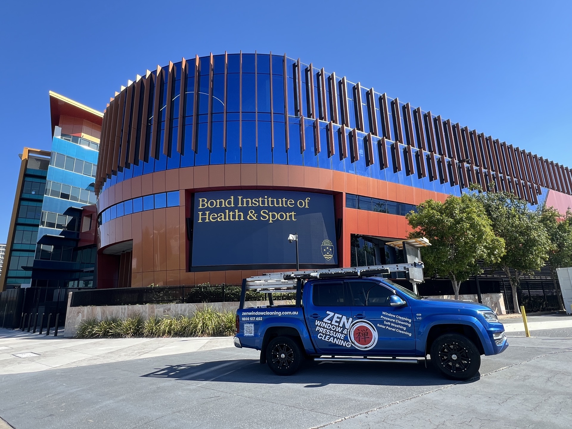 Zen Window Cleaning ute at the Bond Institute of Health and Sport building in Robina